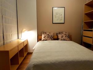 a small bedroom with a bed and a desk at Gustav House in Daugavpils