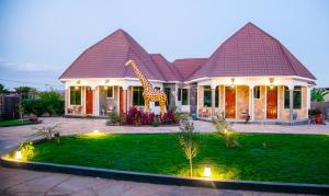 a house with a giraffe on the front of it at Asmorein Hotel in Babati
