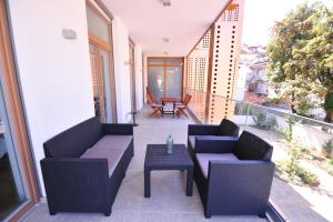 a balcony with two chairs and a table at Argo Apartments in Ljubljana