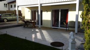 a patio in front of a house with a table at Ferienwohnung Valentin in Hohenpeißenberg