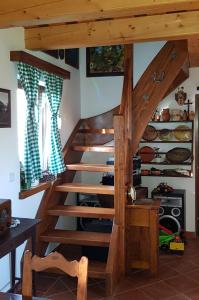 a wooden staircase in a room with a kitchen at Apartma Lipek in Pristava