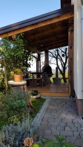 an outdoor patio with a wood porch with a fireplace at Apartma Lipek in Pristava