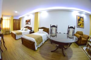 Ένα ή περισσότερα κρεβάτια σε δωμάτιο στο El Gran Hotel de Pereira