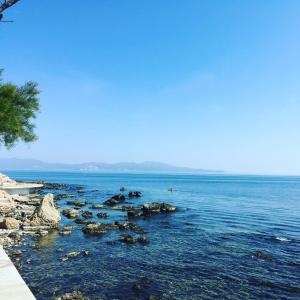 a view of a body of water with rocks at 2 bedroom apartment in the old town, close to the beach in L'Escala