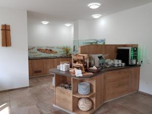 a kitchen with a counter with a coffee maker at Hotel Rimo in Ort im Innkreis