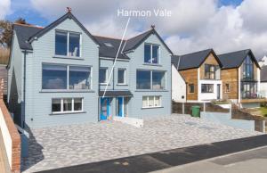 a blue house with a driveway in front of it at Harmon Vale in Solva