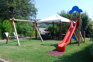 a playground with a slide and a slideintend at Cumana Blu Apartments in Campofilone