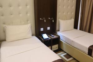 Postel nebo postele na pokoji v ubytování Al Khaleej Grand Hotel