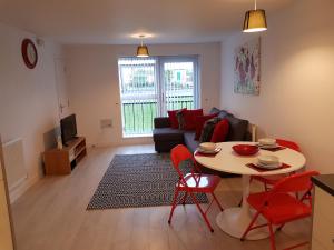 a living room with a table and a couch at Vetrelax Blake Lodge in Basildon