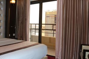 Postel nebo postele na pokoji v ubytování Al Khaleej Grand Hotel
