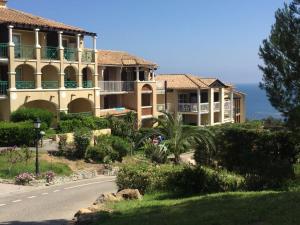 a large building on the side of a road at Appartement à Cap Estérel Village Pierre et Vacances Piscines et parking inclus in Agay - Saint Raphael