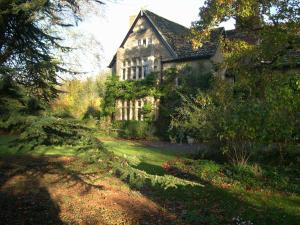 an old house in the middle of a yard at Lullington House in Frome