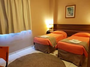Postel nebo postele na pokoji v ubytování Astro Hotel