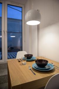 a dining room table with two bowls on it at Willow Pillow Nowowiejska in Warsaw