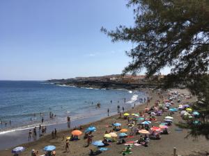 La GaritaにあるSeaside Apartment Gran Canariaの傘持ちの浜辺の人々