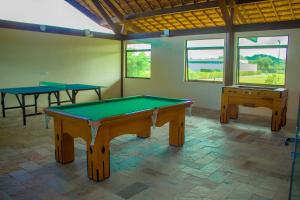 a room with two ping pong tables in it at Carneiros Beach Particular Flat in Praia dos Carneiros