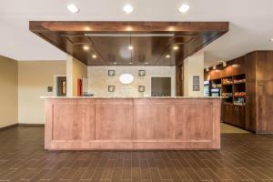 a kitchen with a wooden floor and wooden cabinets at Comfort Suites Denver near Anschutz Medical Campus in Aurora