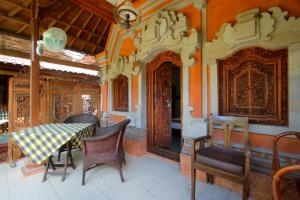 Hotel Jati Sanur في سانور: غرفة طعام مع طاولة وكراسي