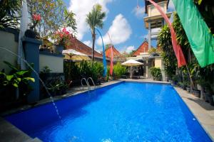 a swimming pool in the middle of a building at Hotel Jati Sanur in Sanur