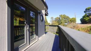 a balcony with windows on a house at @ Marbella Lane Eco Friendly Treehouse, SFO in Brisbane