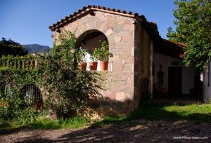 a brick building with a window and plants on it at Posada de la Mision, Hotel Museo y Jardin in Taxco de Alarcón