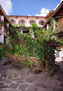 a wooden planter filled with flowers in front of a building at Posada de la Mision, Hotel Museo y Jardin in Taxco de Alarcón