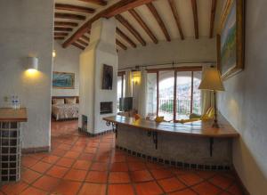 a large room with a table in the middle of a room at Posada de la Mision, Hotel Museo y Jardin in Taxco de Alarcón