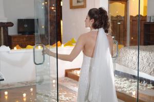a woman in a wedding dress holding a door at Posada de la Mision, Hotel Museo y Jardin in Taxco de Alarcón