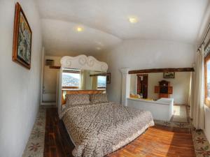 a bedroom with a large bed in a room at Posada de la Mision, Hotel Museo y Jardin in Taxco de Alarcón