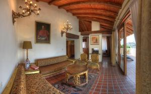 a living room with a couch and a table at Posada de la Mision, Hotel Museo y Jardin in Taxco de Alarcón
