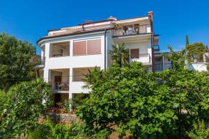 an apartment building with trees in front of it at Two-Bedroom Apartment in Crikvenica XXXVI in Dramalj