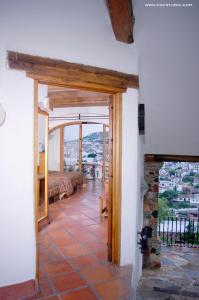 a room with a view of a room with a fireplace at Posada de la Mision, Hotel Museo y Jardin in Taxco de Alarcón