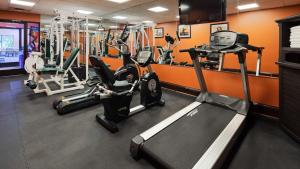 a gym with several tread machines in a room at Best Western Plus Georgetown Corporate Center Hotel in Georgetown