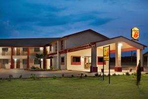 a hotel with a sign in front of it at Super 8 by Wyndham Corsicana in Corsicana