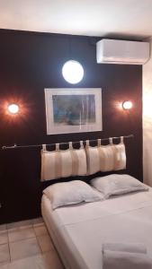 圣丹尼斯Hôtel Du Centre的一间卧室设有黑色墙壁、一张床和两个灯