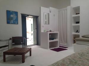 a white living room with a couch and a table at Patio II studio at finca in La Asomada