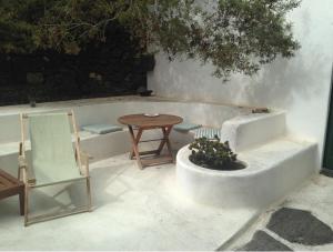 a patio with a table and chairs and a tub at Patio II studio at finca in La Asomada