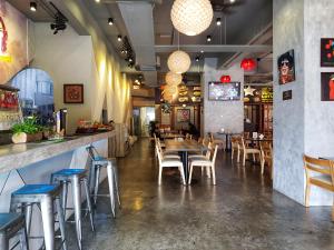 a restaurant with tables and chairs and a bar at No.1 The Muji @ Puchong Skypod Residence in Puchong