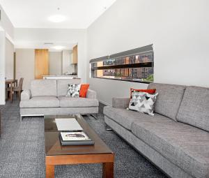 a living room filled with furniture and a couch at Melbourne CBD Central Apartment Hotel in Melbourne