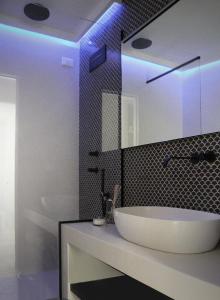 a bathroom with a white tub and a blue light at MADA Charm Apartments Terrace&Carugio in Vernazza
