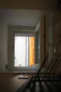 a window in a kitchen with a view of a building at MADA Charm Apartments Terrace&Carugio in Vernazza