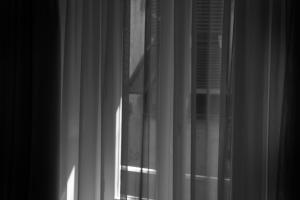 a black and white photo of a window with curtains at MADA Charm Apartments Terrace&Carugio in Vernazza
