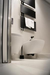 a white bathroom with a sink and a toilet at MADA Charm Apartments Terrace&Carugio in Vernazza