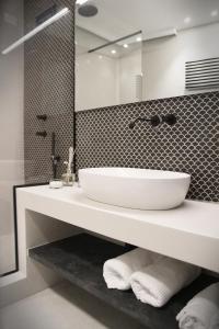 a bathroom with a white sink and a mirror at MADA Charm Apartments Terrace&Carugio in Vernazza