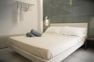 a bedroom with a white bed with a pillow on it at MADA Charm Apartments Terrace&Carugio in Vernazza