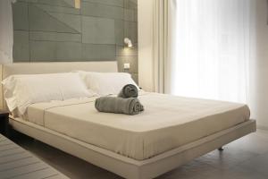 a white bed with a towel on it in a bedroom at MADA Charm Apartments Terrace&Carugio in Vernazza
