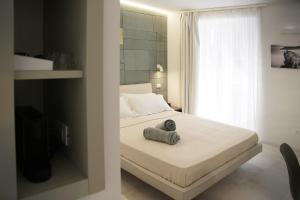 A bed or beds in a room at MADA Charm Apartments Terrace&Carugio