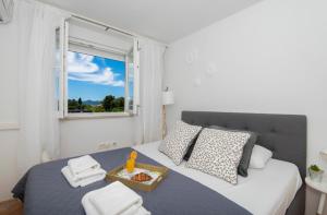 a bedroom with a bed with a tray of food on it at Apartment Lita Center in Zadar