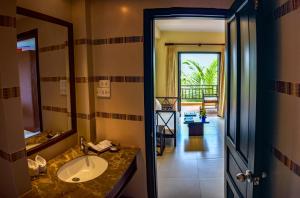 a bathroom with a sink and a mirror at Pandanus Resort in Mui Ne