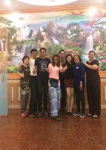 a group of people standing in front of a mural at Lam Dat Hotel in Ninh Binh